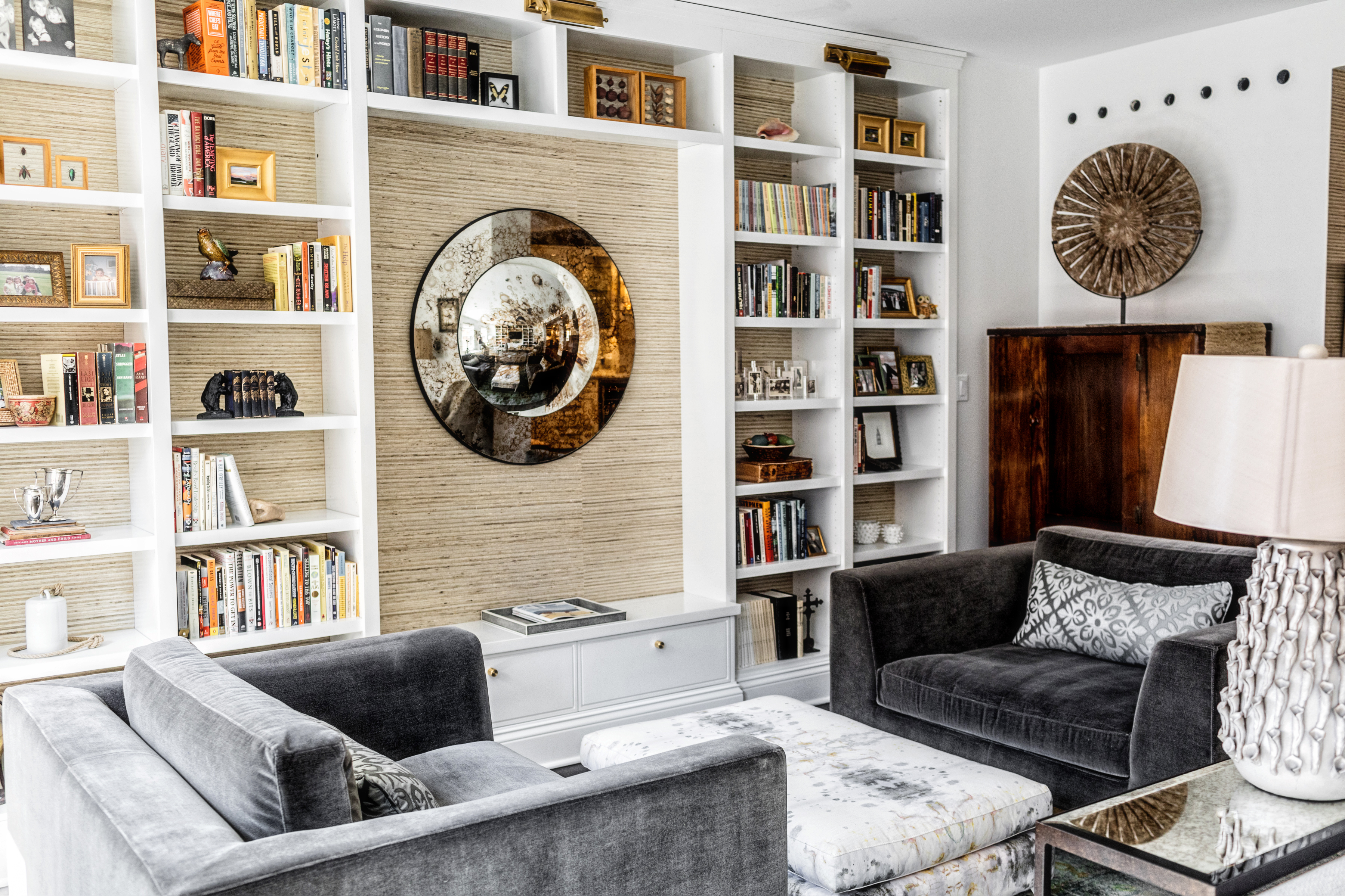 modern bookcase, mirror and armchairs