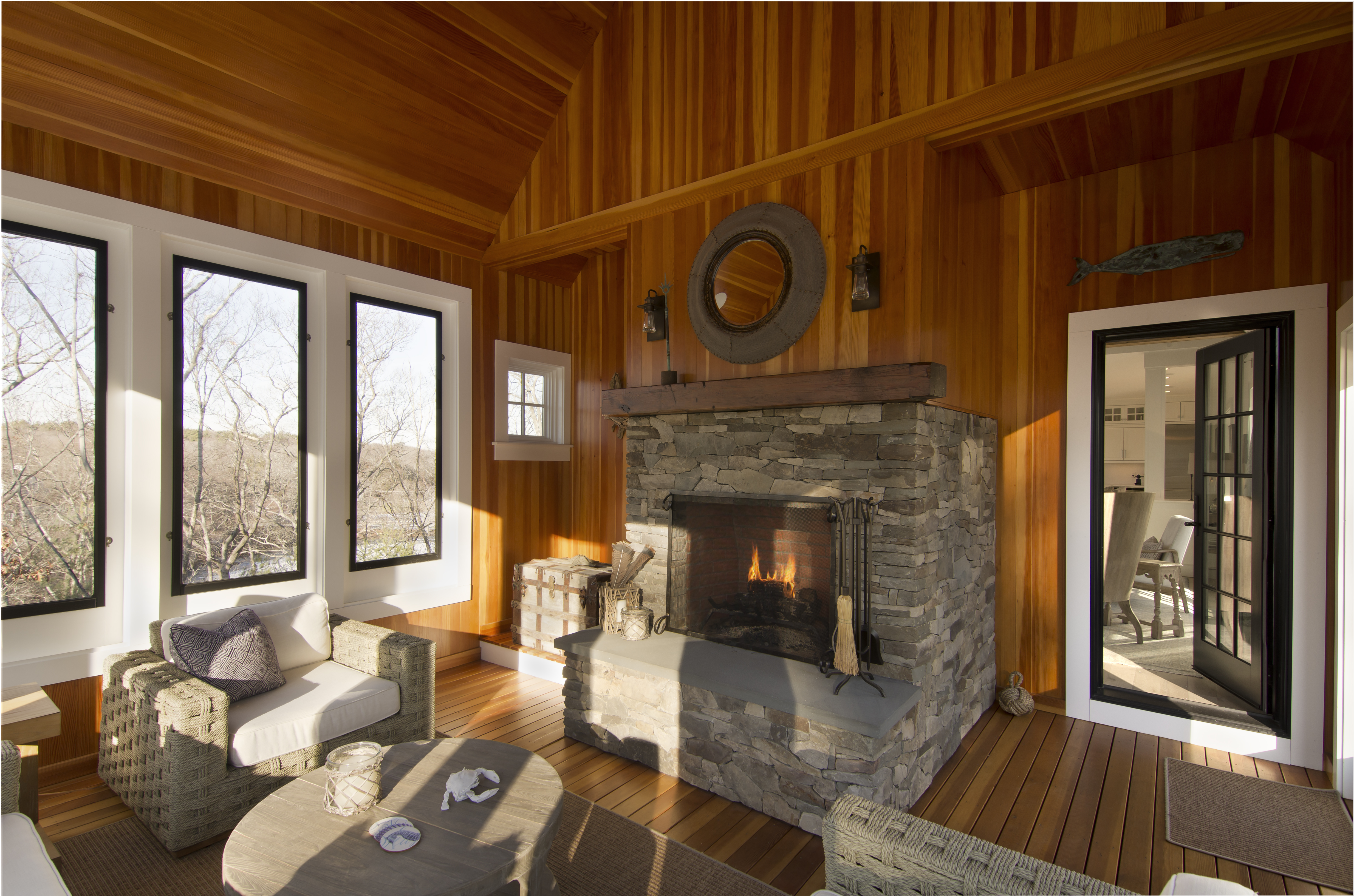room with wooden walls and stone fireplace