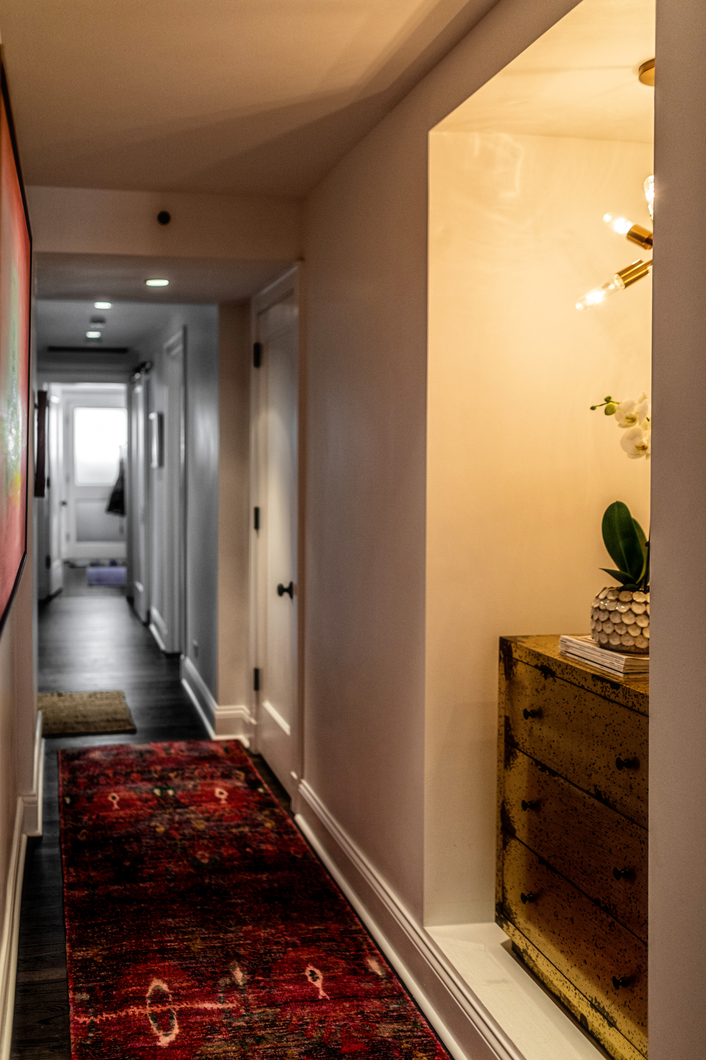 long hallway with colorful rug